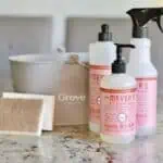 Grove Collaborative cleaning products including hand soap and spray bottles on a kitchen counter.