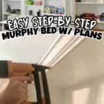 Installing a Murphy bed with plans in a bright, organized room with bookshelves.