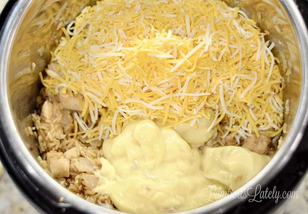cheese and soup added to cooked chicken and rice in an instant pot.