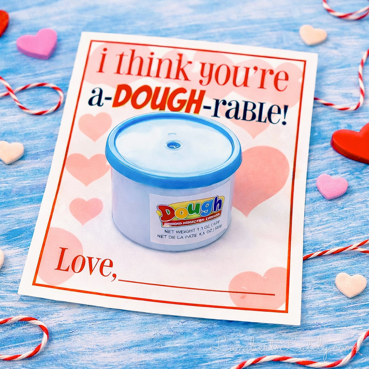 a mini play doh cup attached to the i think you're a-dough-rable printable valentine.