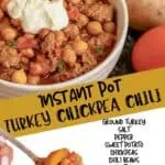 Delicious turkey chili with chickpeas, tomatoes, and spices in a white bowl.