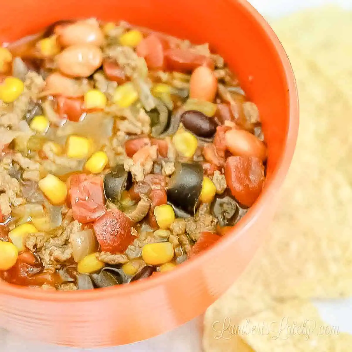 bowl of 7 can taco soup next to tortilla chips.