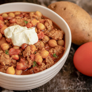 turkey chili in a bowl, topped with sour cream.