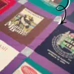 Colorful T-shirt quilt with various vintage and themed T-shirts, perfect for DIY projects.