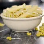 Bowl of cooked pasta with decorative overlay for 'How to Make Instant Pot Pasta'.