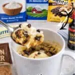 Chocolate chip mug cake with milk and baking ingredients on a kitchen counter.