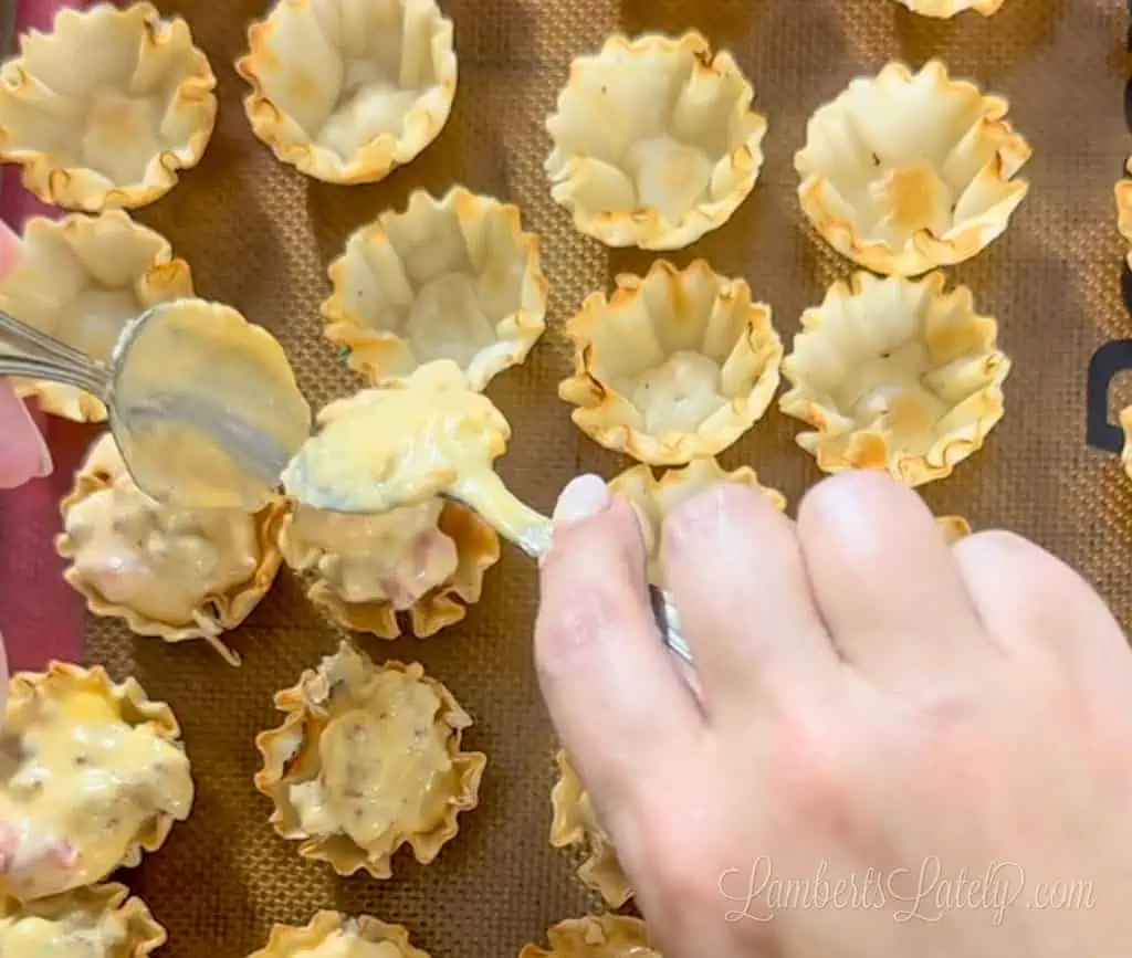scooping filling into phyllo shells.