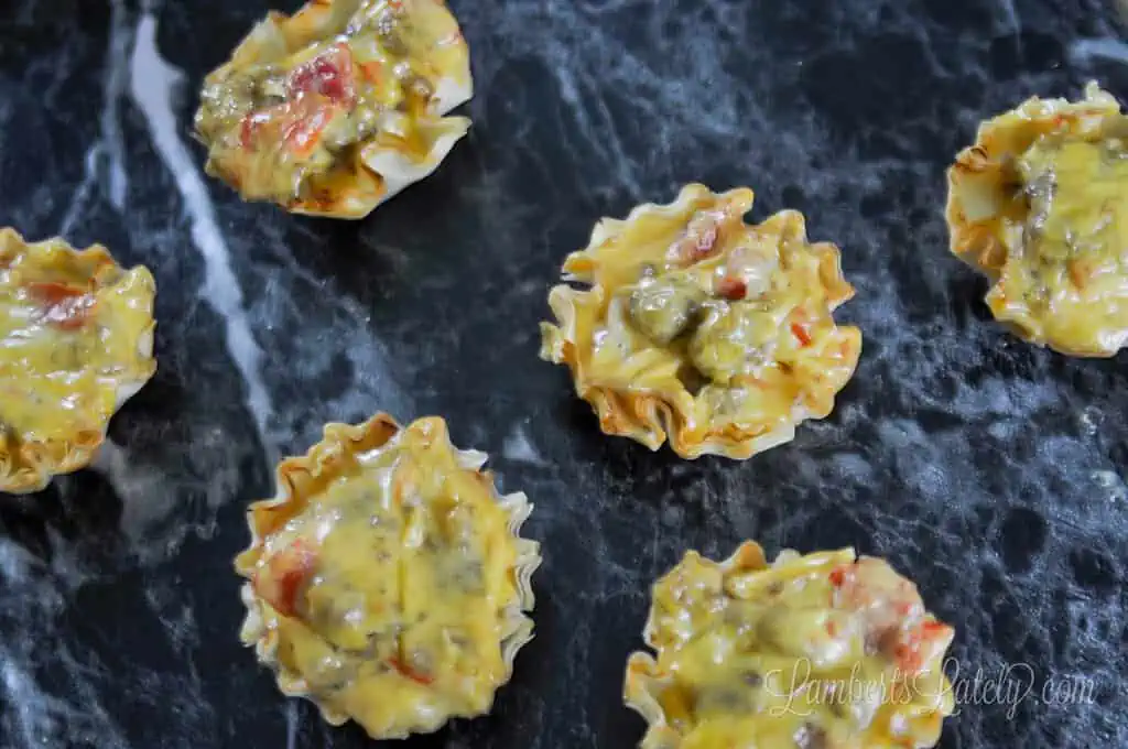 cheesy sausage rotel cups on a counter.