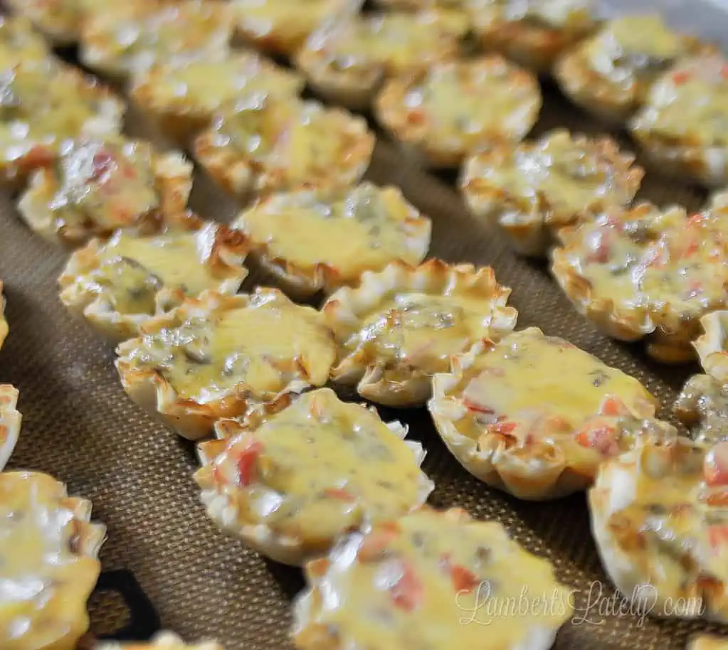 cheesy sausage rotel cups on a baking sheet.