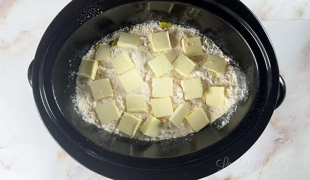 butter on top of cake mix in a crock pot.
