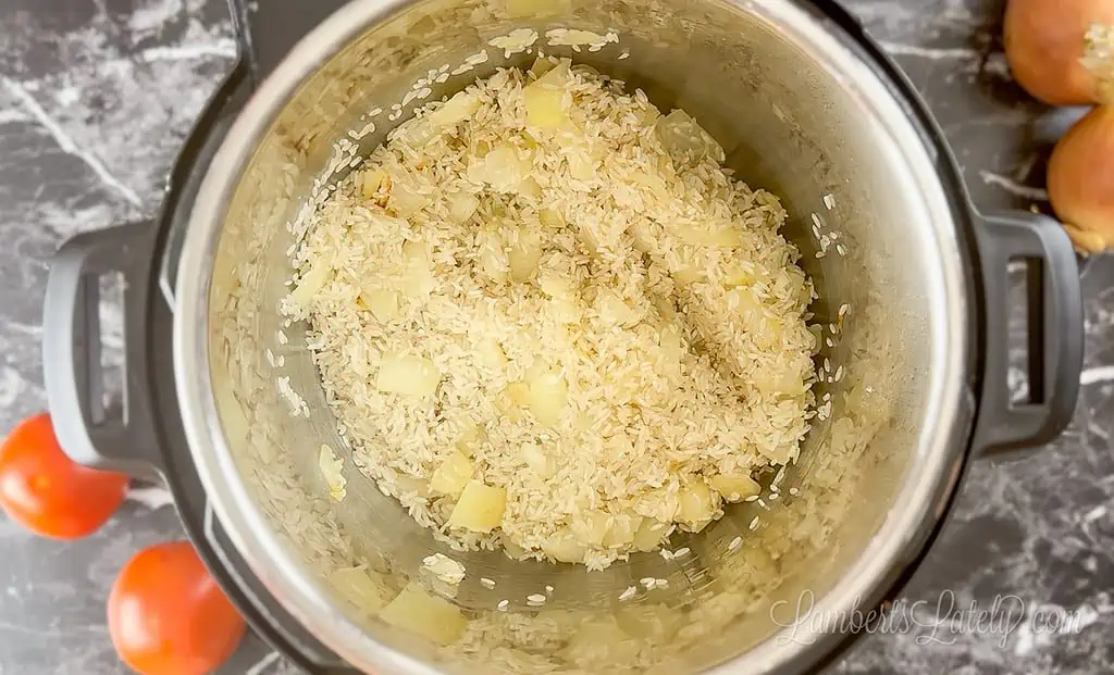 butter, rice, and onion in an instant pot.