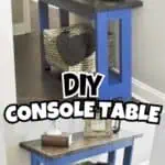 DIY console table with a dark top and bright blue legs, decorated with plants and candles.