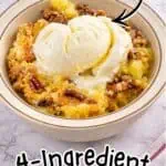 Delicious pineapple dump cake with vanilla ice cream and crumble topping.