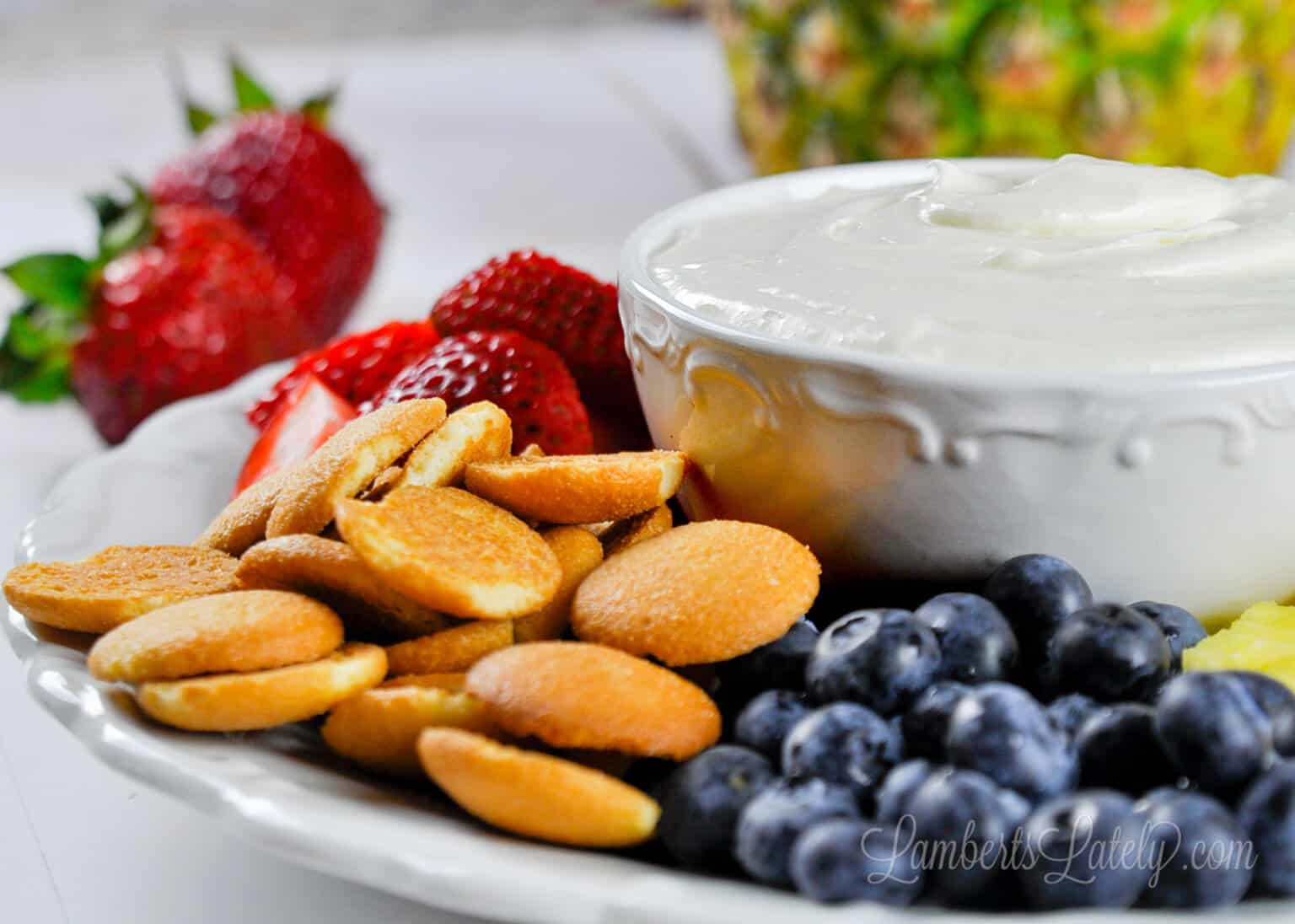 cream cheese fruit dip with vanilla wafers, strawberries, blueberries.