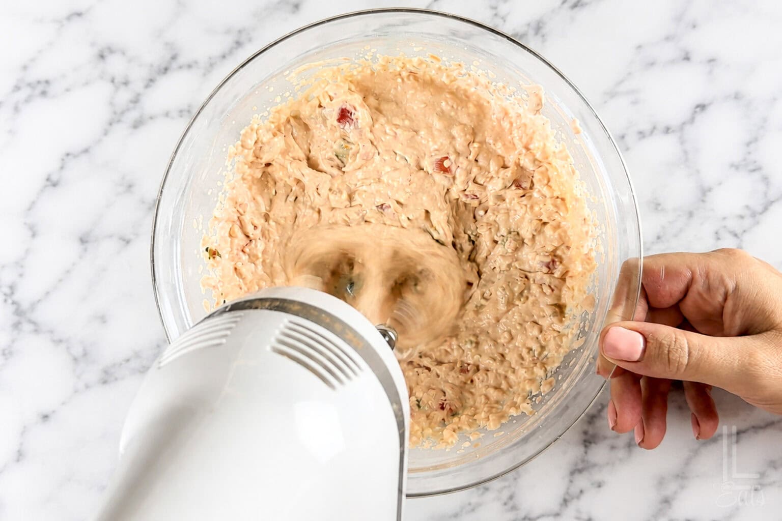 blending cream cheese and salsa in a bowl.