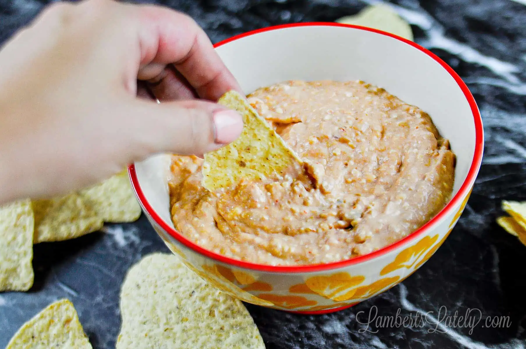 dipping a chip into dip.