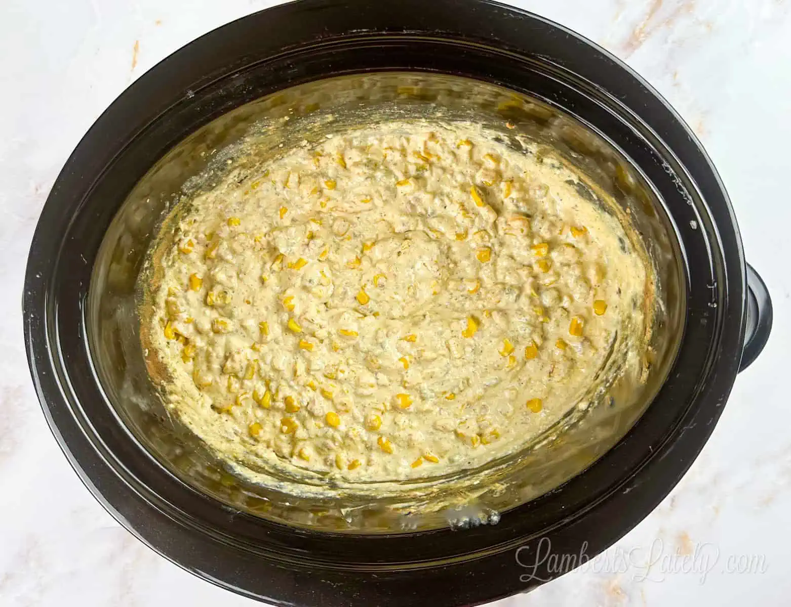 corn dip with cream cheese in a slow cooker.