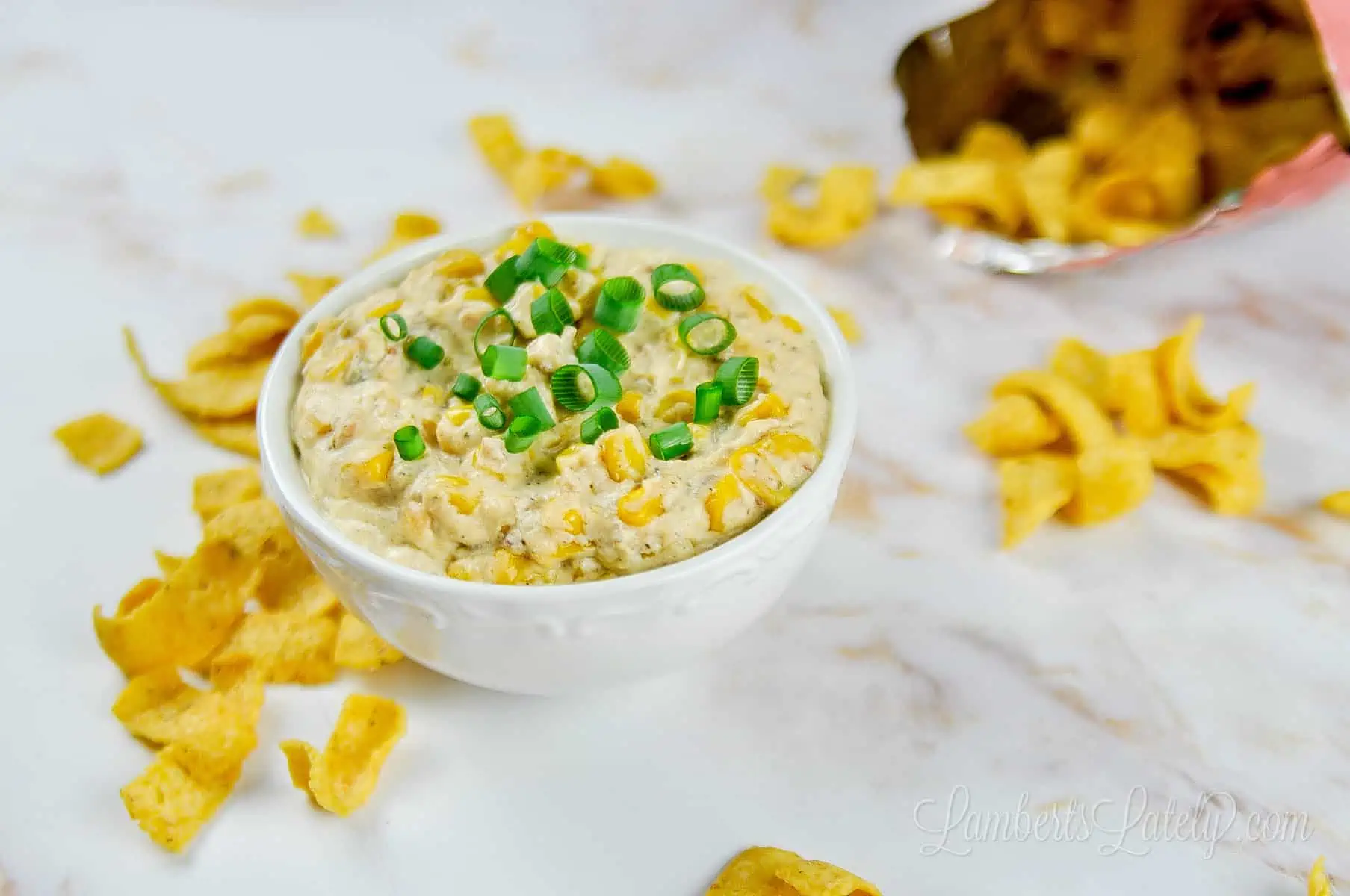 crack corn dip in a bowl with corn chips and bag.