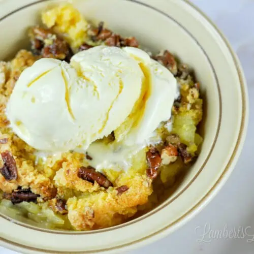 bowl of pineapple dump cake with ice cream.