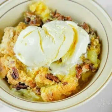 bowl of pineapple dump cake with ice cream.