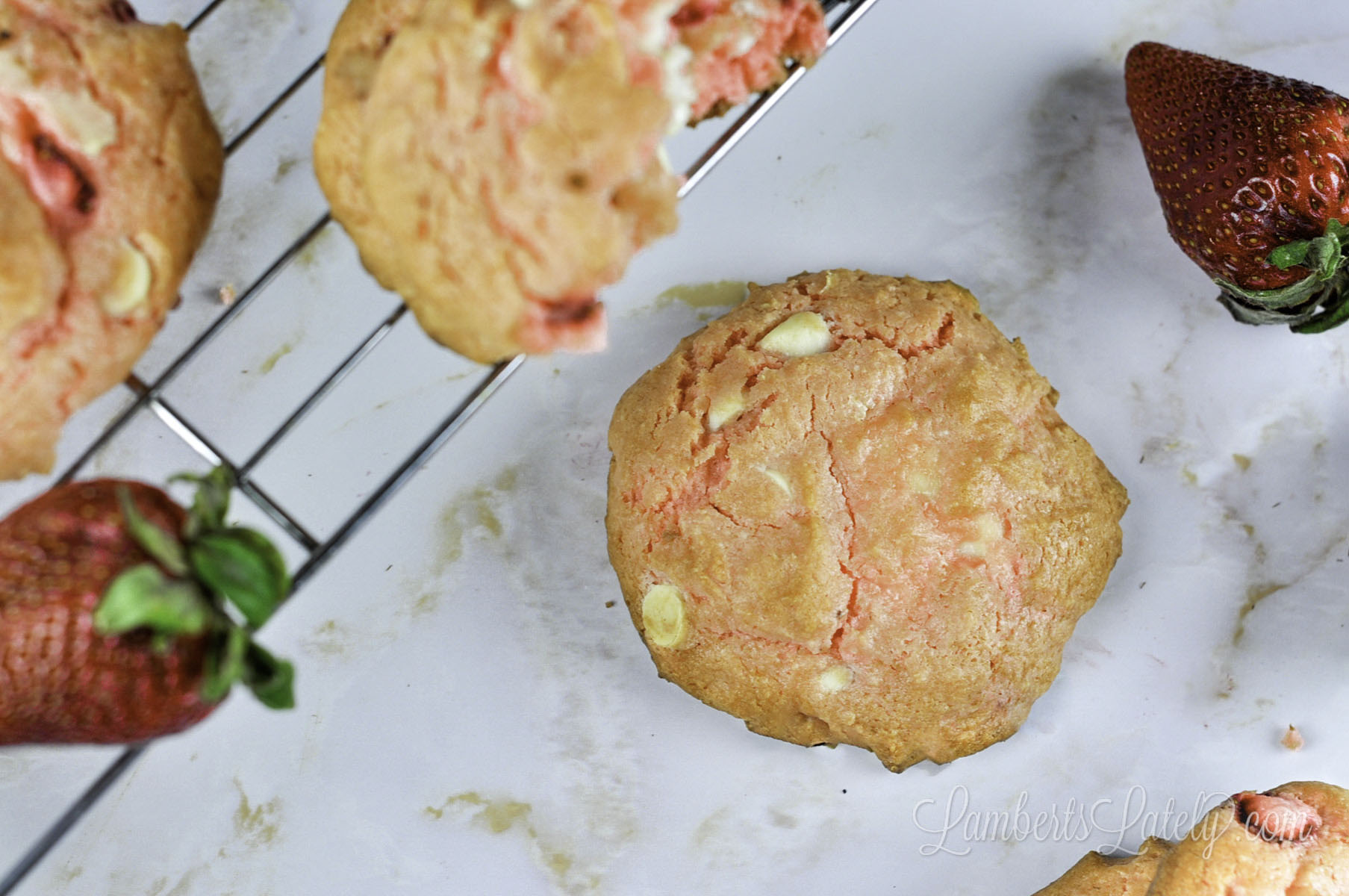 strawberry cheesecake cookie next to a baking rack.