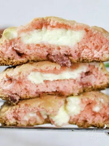 three strawberry cheesecake cookies on a baking rack.