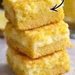 Lemon Chess Squares with a cheesecake center, topped with lemon glaze, on a white plate.