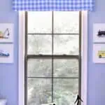 DIY window cornice board with foam board and blue gingham fabric for home decor.