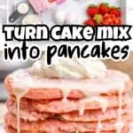 Stacked pink cake pancakes with icing syrup and strawberries on a white plate.
