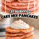 Stack of strawberry cake mix pancakes with icing syrup and whipped cream.