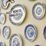 Decorative blue and white plates arranged on a wall for DIY kitchen gallery display.