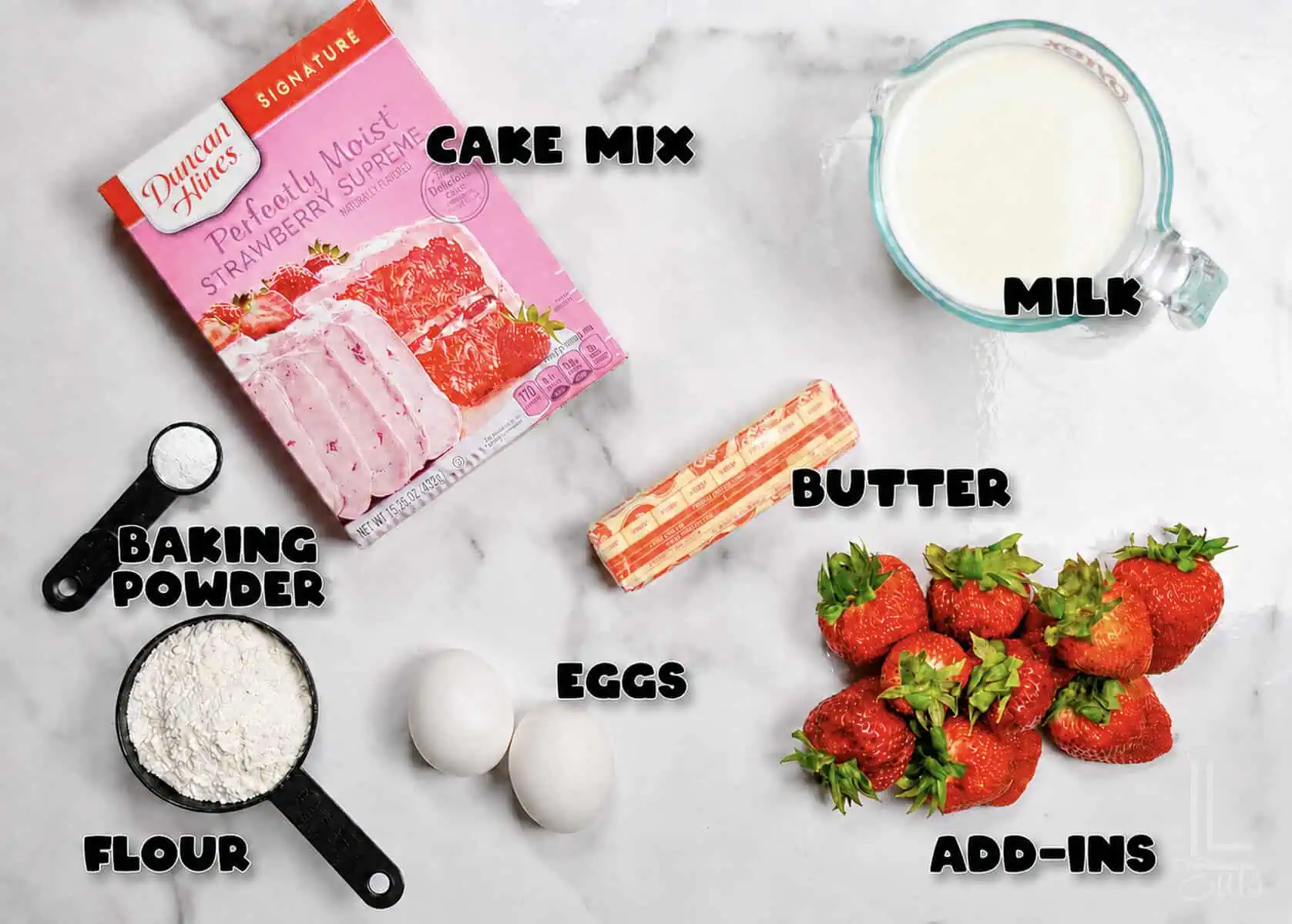 Ingredients for cake mix pancakes with boxed mix, flour, and milk on a white surface.