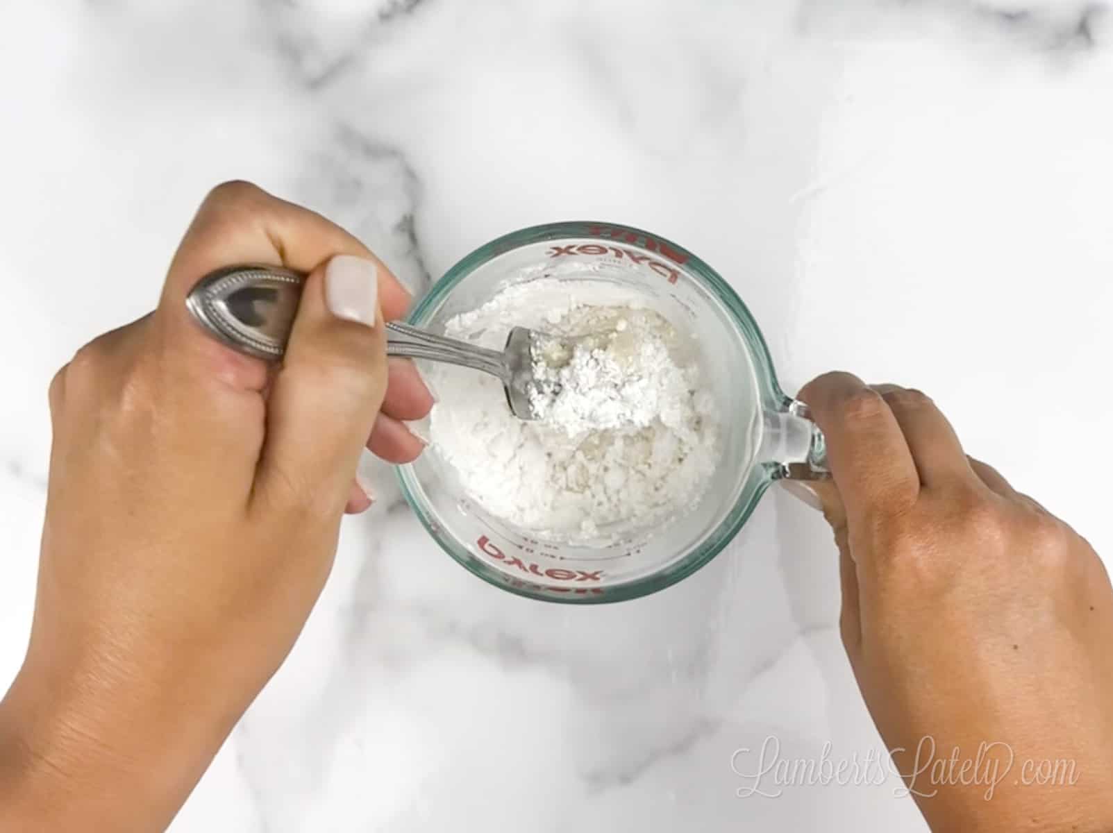 stirring together powdered sugar, half and half, and vanilla extract in a measuring cup.