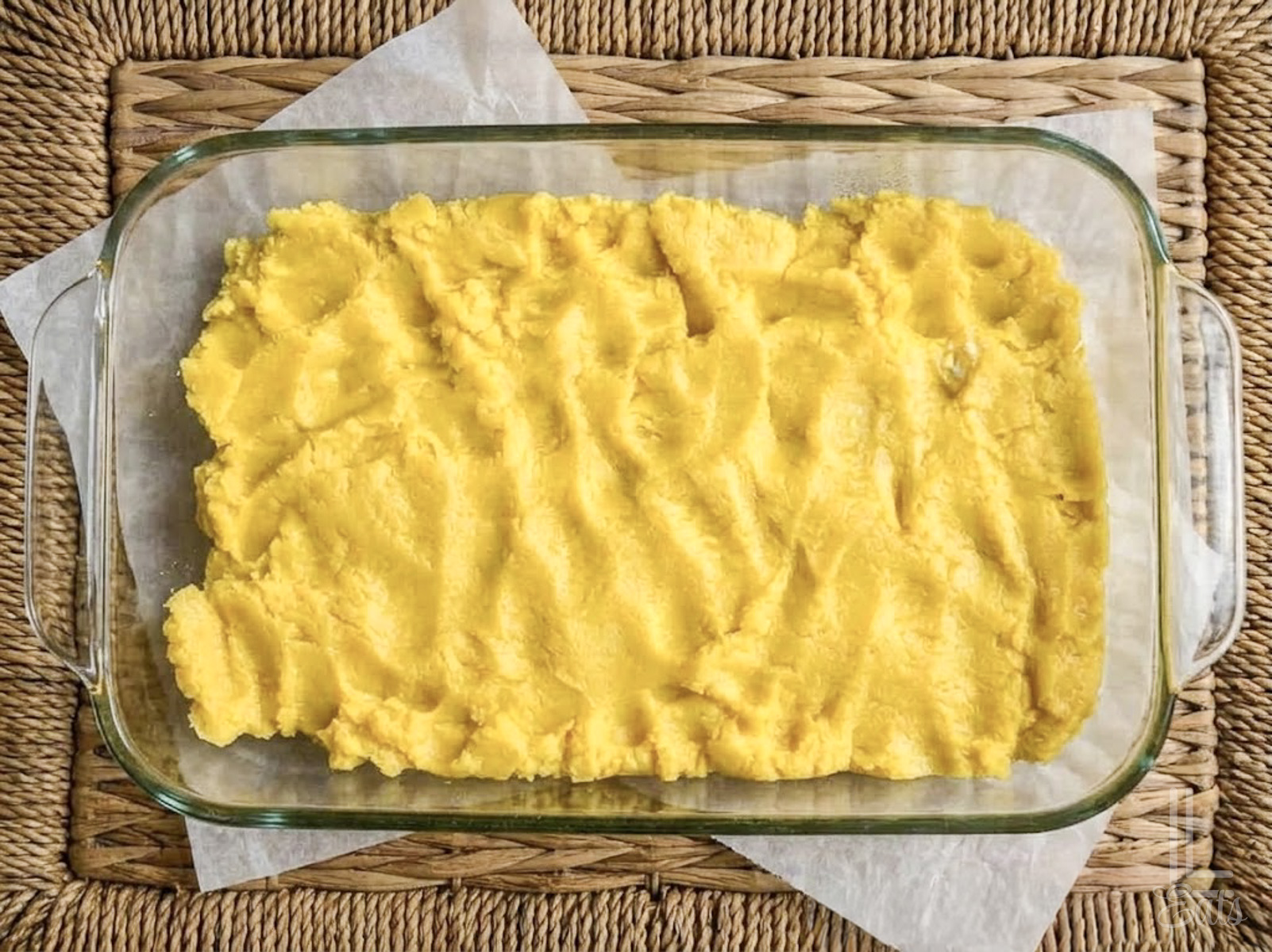 cake layer of lemon chess bars spread in a 7x11" glass baking dish.