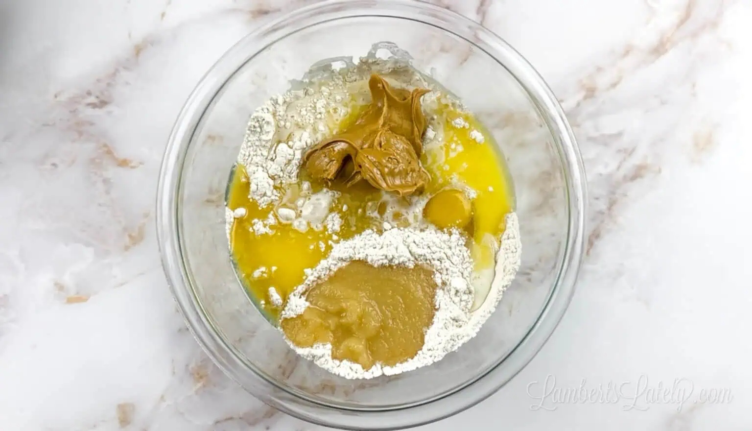 Mixing flour, eggs, and peanut butter for baking.