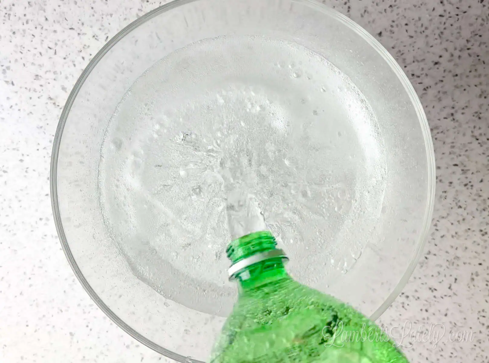 pouring lemon lime soda into a punch bowl.