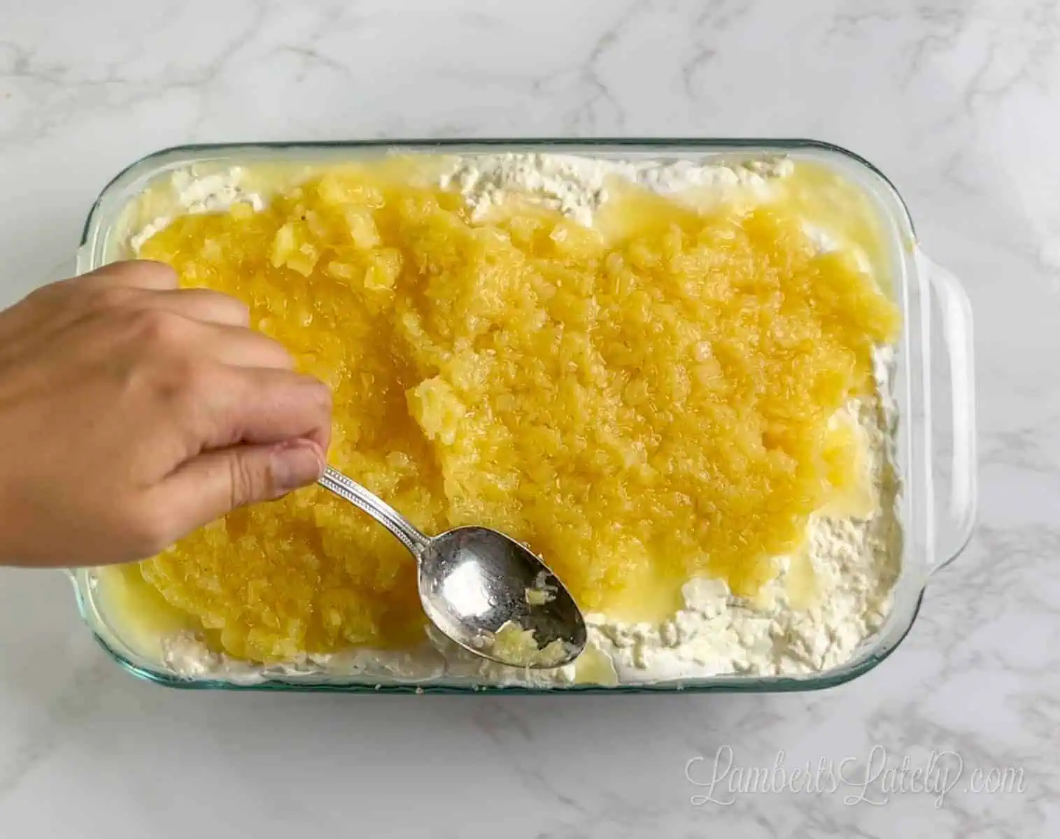 spreading crushed pineapple over banana cream layer.