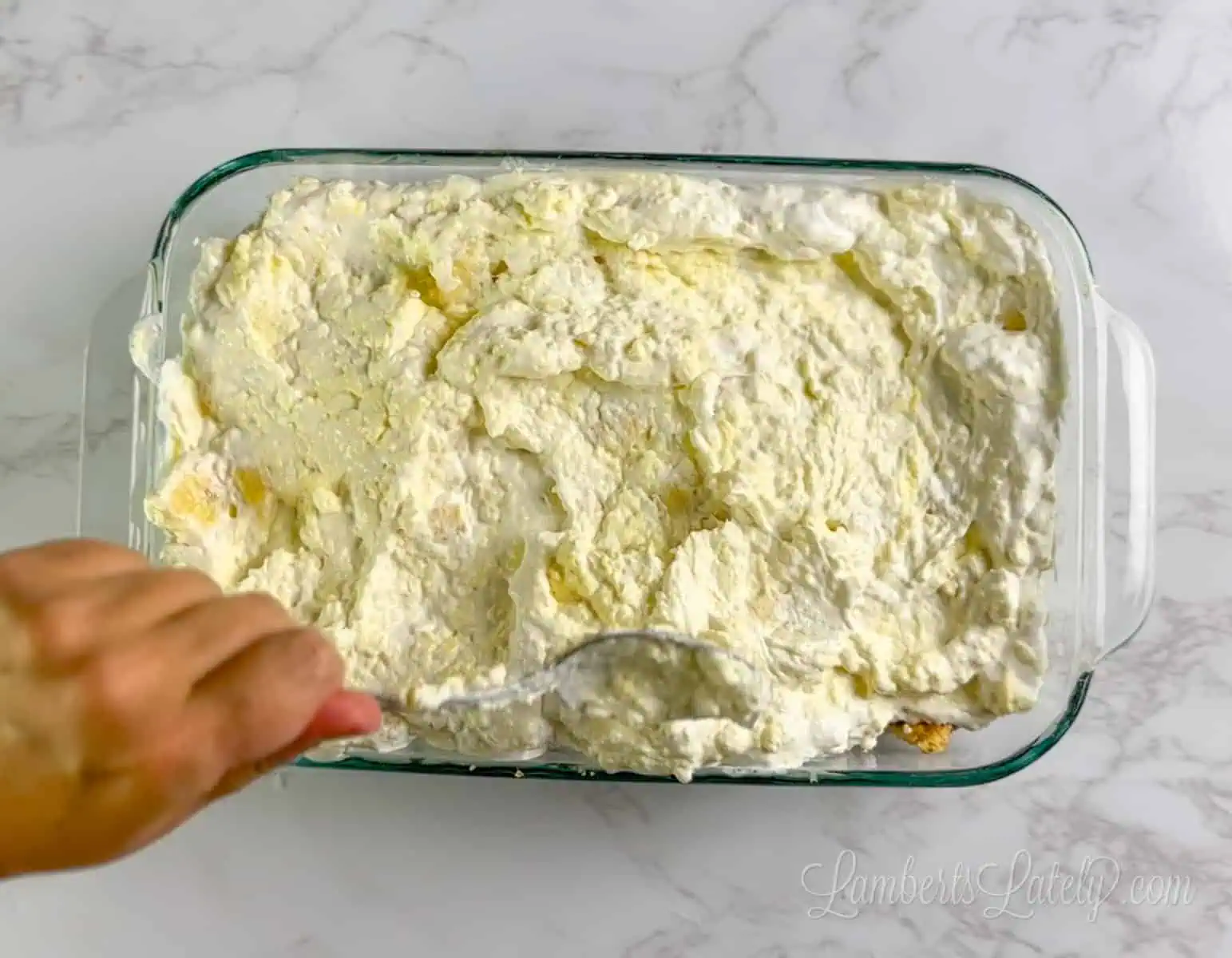 spreading banana cream layer over graham cracker crust.