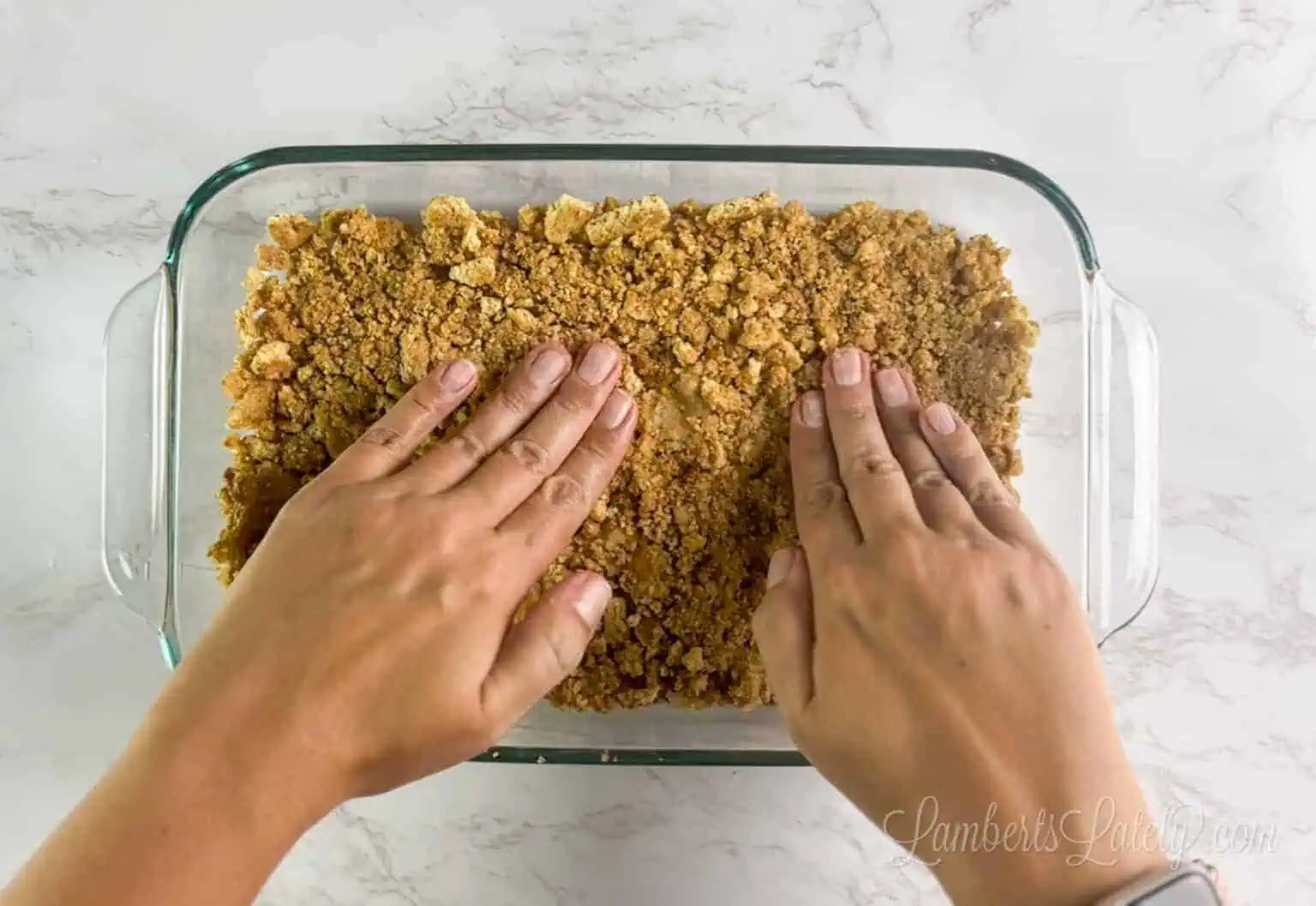 pressing the graham cracker crust into a glass 11x7 inch baking dish.