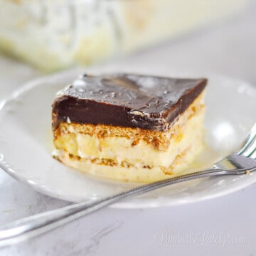 piece of chocolate eclair cake on a plate with a fork.