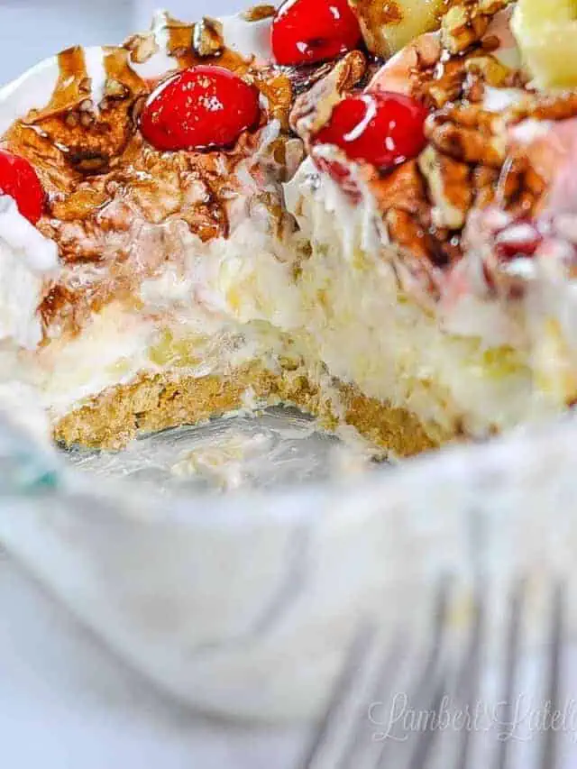 Looking into a banana split cake that's been cut, in a baking dish.