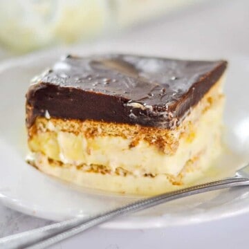 piece of chocolate eclair cake on a plate with a fork.