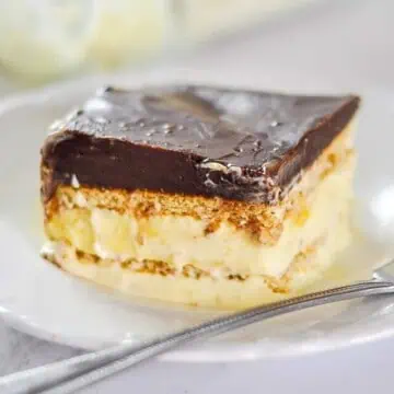 piece of chocolate eclair cake on a plate with a fork.