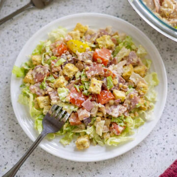 plate full of italian hoagie salad with a fork.
