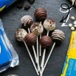 Delicious Oreo cake pops with chocolate coating on sticks, perfect for desserts.