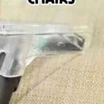 Close-up of a vacuum cleaner cleaning a beige upholstered chair.