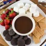 Chocolate dip with marshmallows, strawberries, and cookies for berries.
