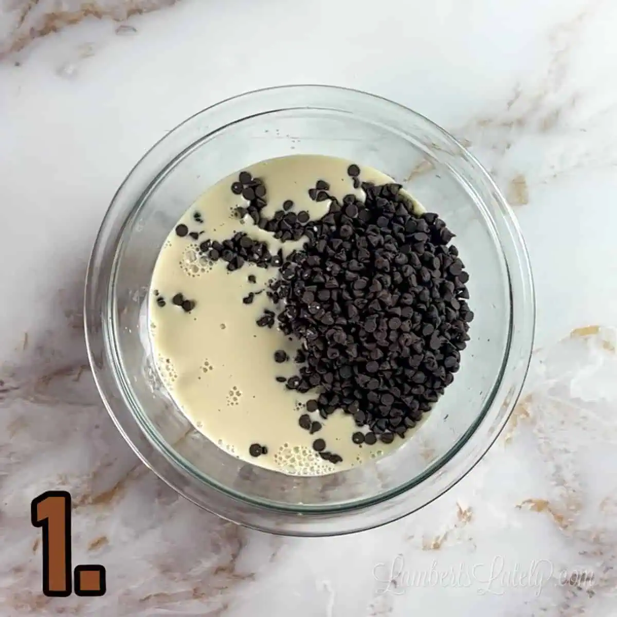 chocolate chips and evaporated milk in a glass bowl.