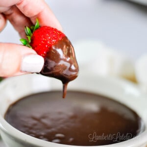 strawberry dipped in chocolate dip, dripping.