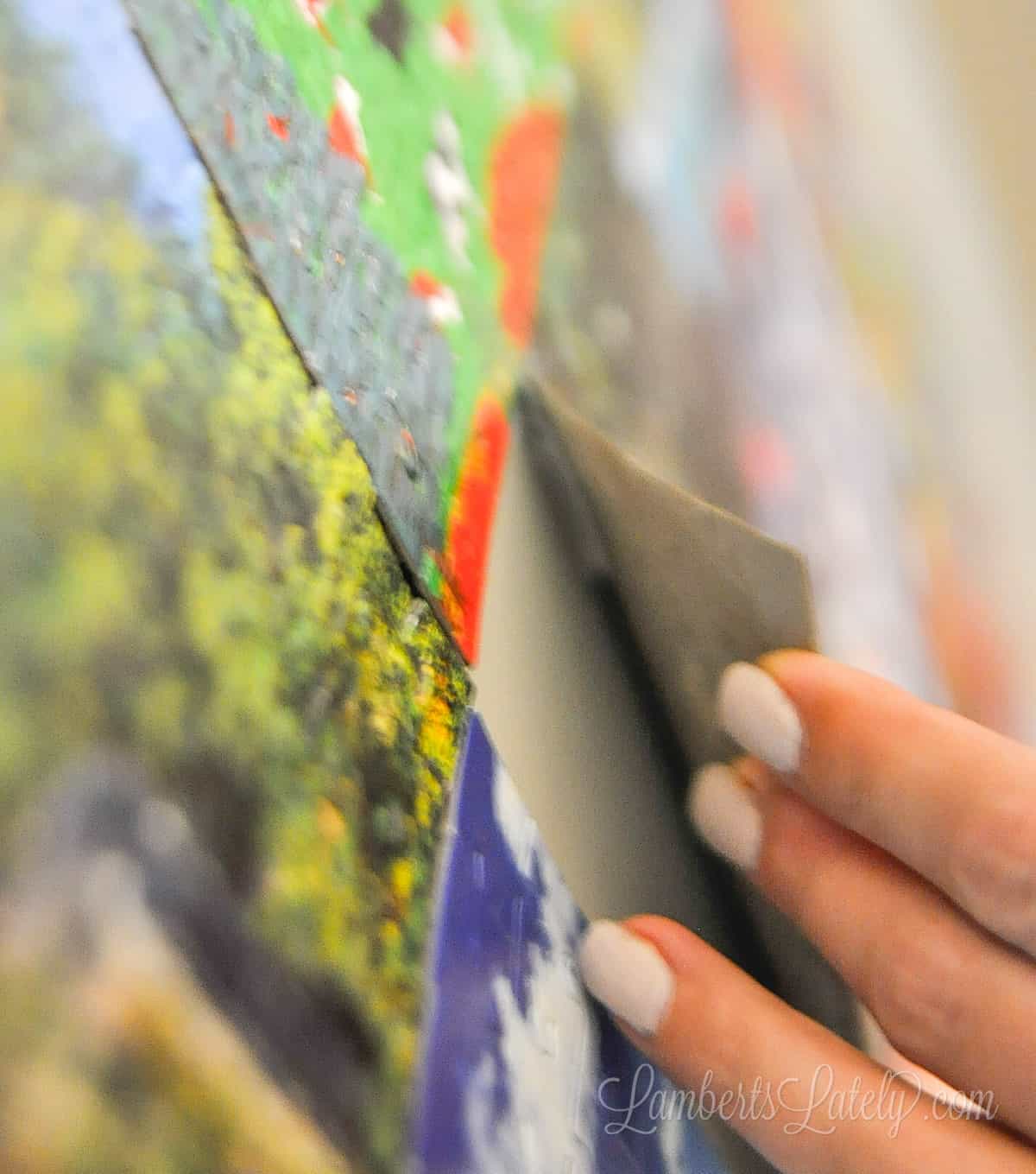 showing back of the glued puzzle with a command strip.